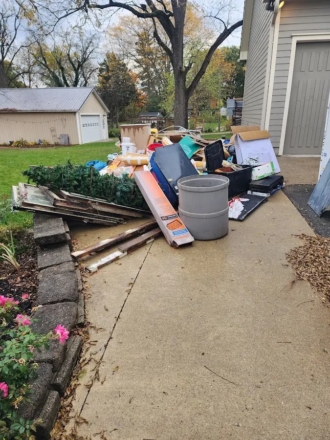 Dumpster being loaded with debris for Estate Cleanout Dumpster Rental in Miami Heights